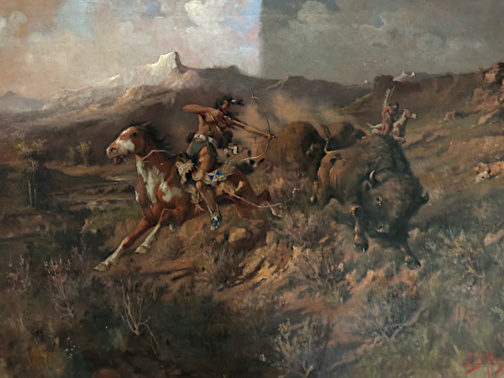 A partially cleaned Old West painting of a buffalo hunt by Edgar Samuel Paxson (1901) reveals richer colors and more detail on the side that has been cleaned.